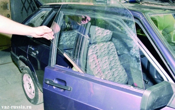 Извлечение бокового стекла, из отверстия, которое находится в двери автомобиля